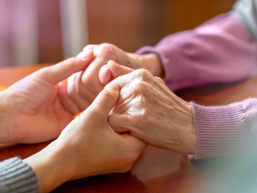 Elderly Hands. Helping Hands Of Young Adult And Senior Women. Ca